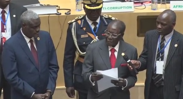 Zimbabwe President Robert Mugabe presents fundraising check of $1 million to the AU Summit