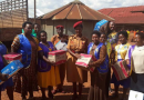 Chrispine Musimenta Rwaboona (on the left of the Police woman) delivering donations to inmates at Ndorwa Prison in Kabale