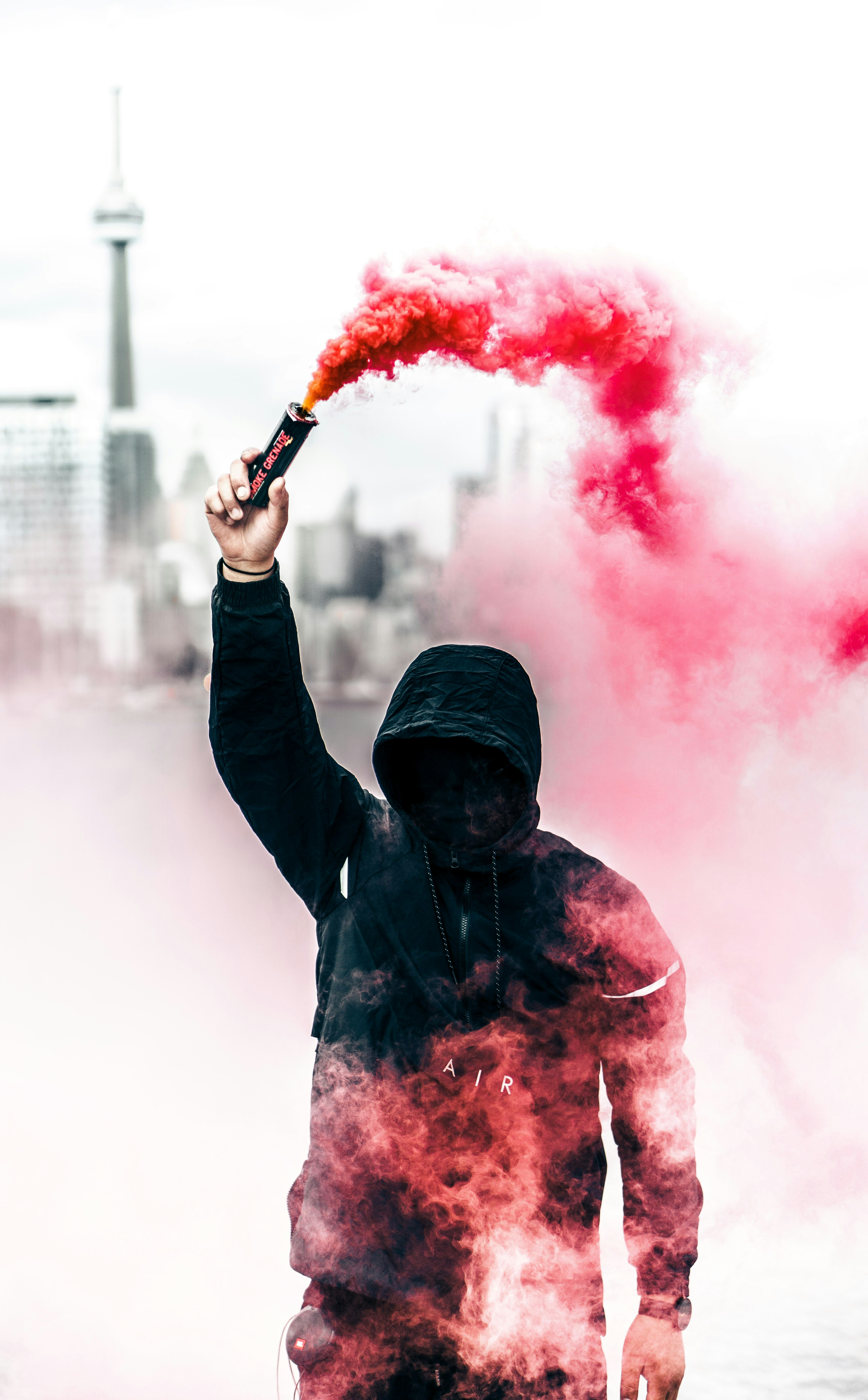 Warren, https://unsplash.com/photos/person-wearing-black-and-red-hoodie-holding-smoke-bomb-bh4LQHcOcxE